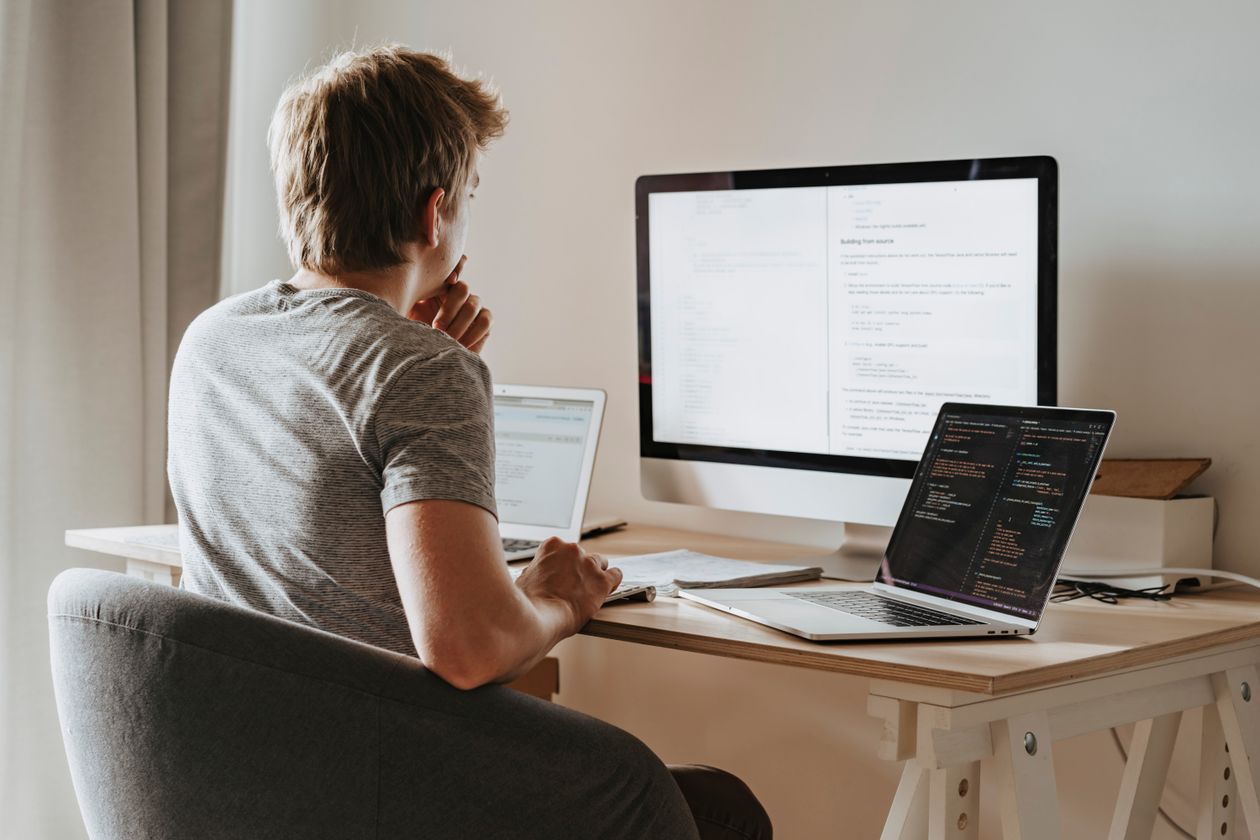 Creator at a desk reading model documentation while setting up a local AI image generation environment